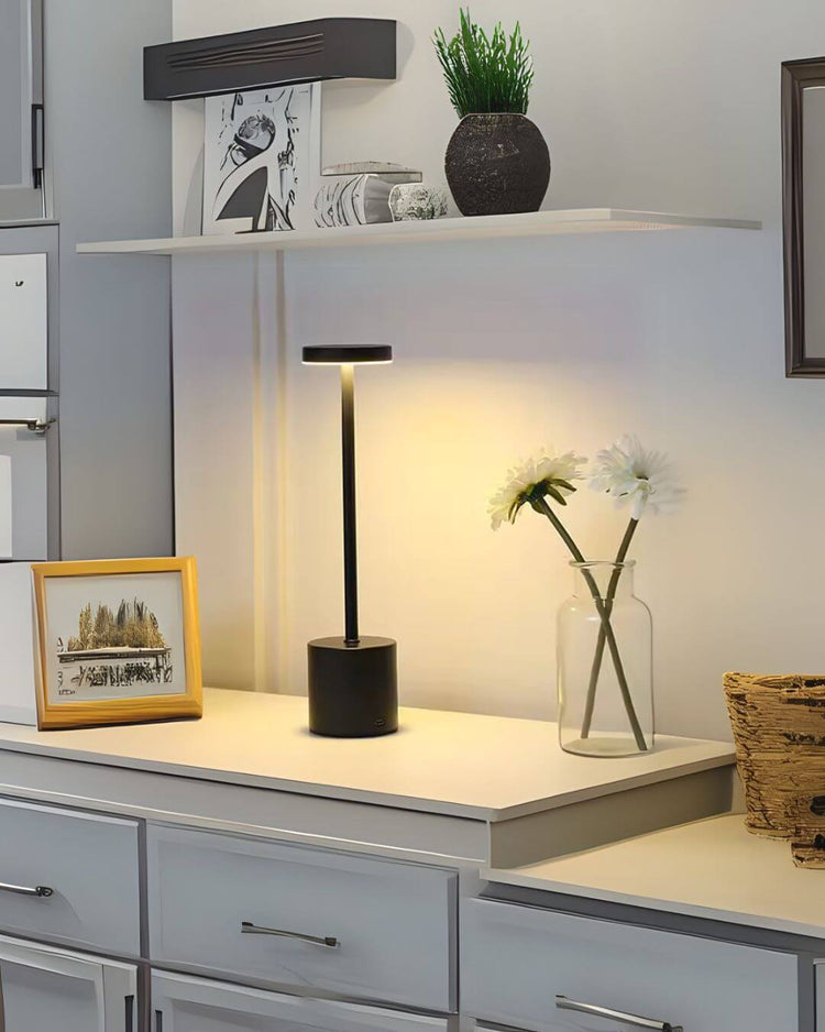 LumiHikari Scandinavian Lamp with sleek black metal design, warm ambient light on white desk with decorative items