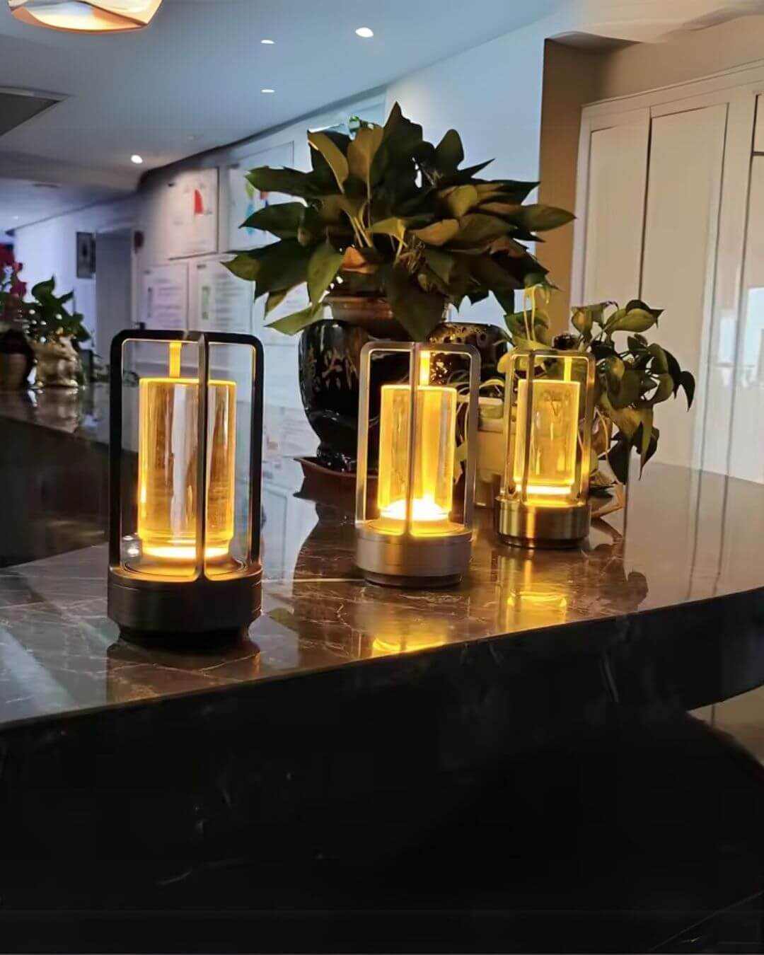 LumiHikari Crystal Lanterns with faceted crystal bodies emitting warm, minimalist ambient light on a reflective surface with indoor plants nearby